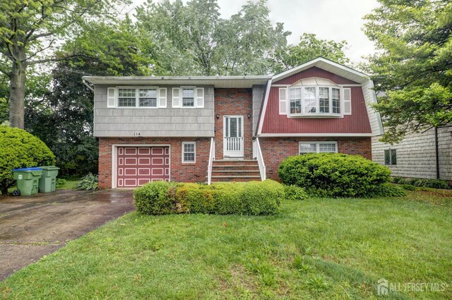 114 Redwood Ave, Edison, NJ 08817 - split foyer home featuring driveway, a garage, a front lawn, a gambrel roof, and brick siding