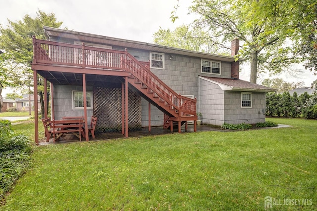 114 Redwood Ave, Edison, NJ 08817 - back of property with a chimney, a deck, a yard, and stairway