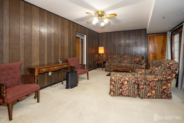114 Redwood Ave, Edison, NJ 08817 - living room featuring light colored carpet, ceiling fan, and wood walls