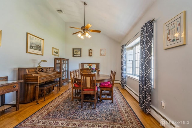 1430 Seneca Rd, North Brunswick, NJ 08902 - dining space featuring wood finished floors, vaulted ceiling, ceiling fan, and a baseboard heating unit