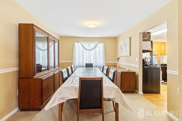 dining space with light colored carpet