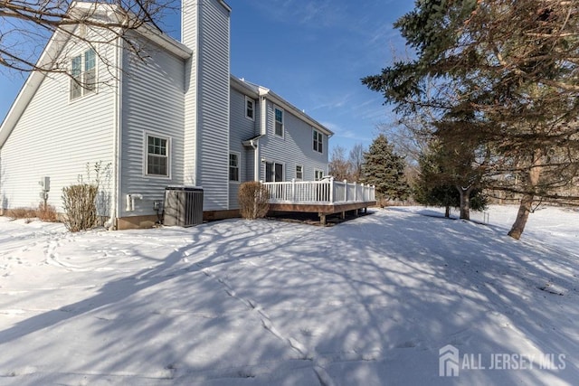 snow covered house with a deck