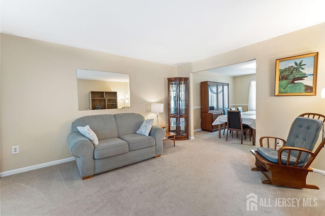 living room with carpet and baseboards