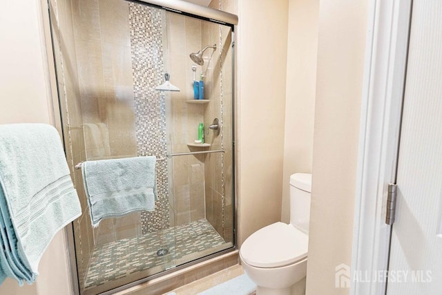 bathroom featuring walk in shower and toilet