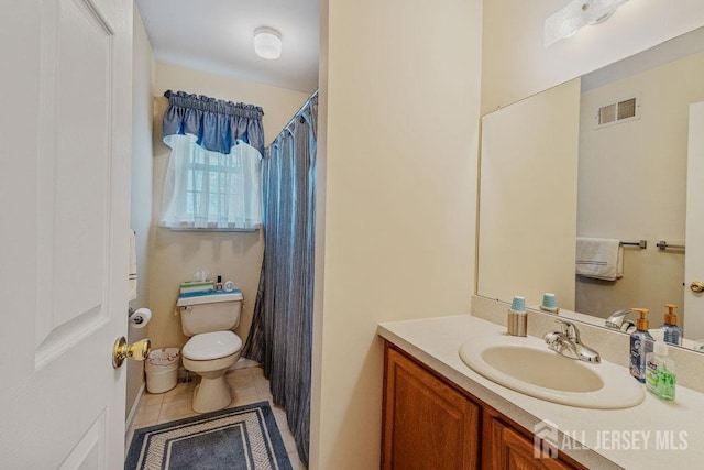 bathroom with vanity, tile patterned floors, and toilet