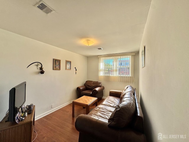 living area featuring dark wood-style floors and baseboards