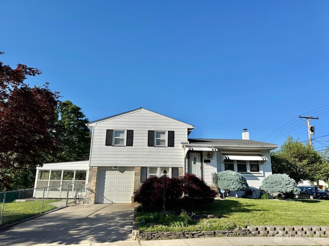 tri-level home with a garage, concrete driveway, a chimney, and stone siding