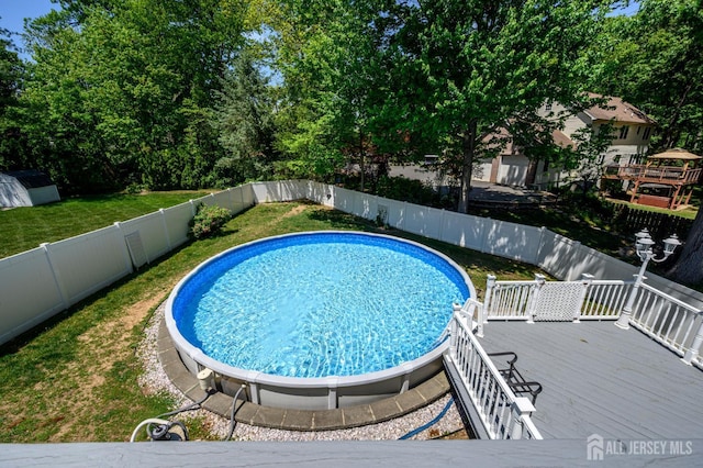 view of pool with a wooden deck
