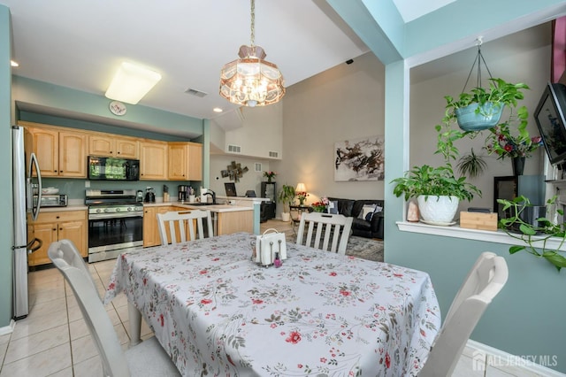 dining space featuring light tile patterned flooring and baseboards
