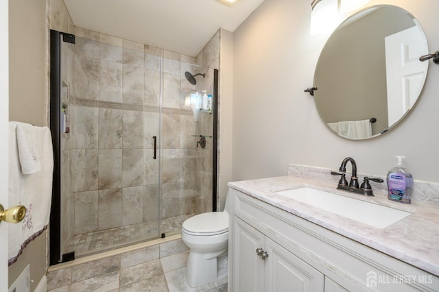 bathroom featuring vanity, toilet, and a shower stall