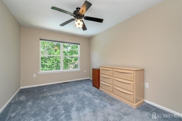 unfurnished bedroom with carpet flooring, baseboards, and a ceiling fan