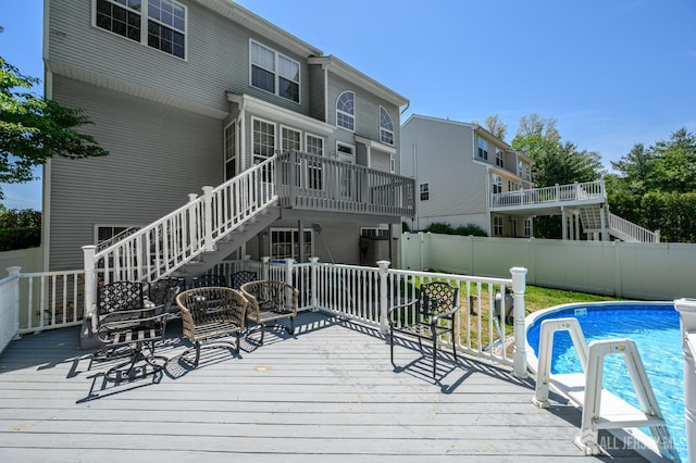 wooden terrace with stairs and a fenced backyard