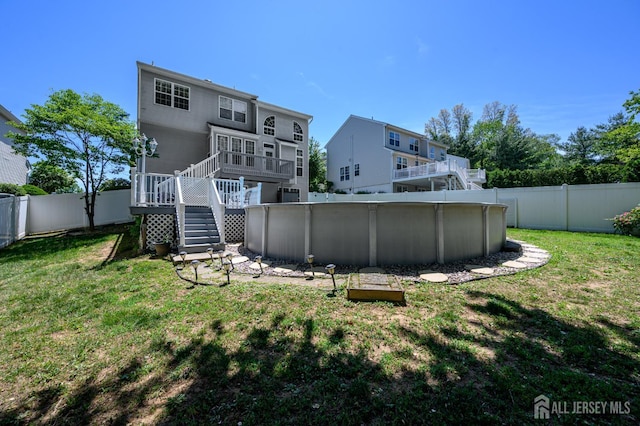 rear view of property featuring stairway and a deck