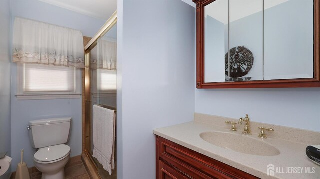 full bath with toilet, a shower stall, and vanity