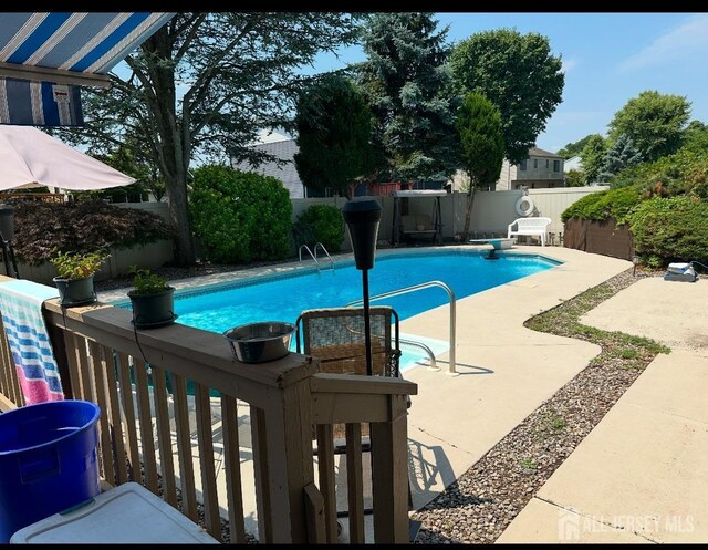 view of swimming pool with a fenced in pool, a patio area, and a fenced backyard