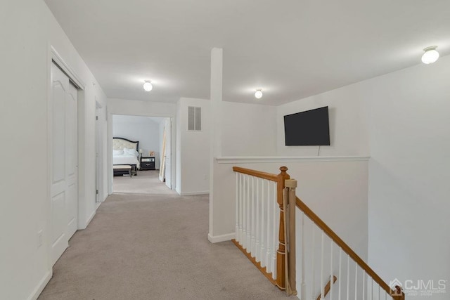 corridor with light colored carpet