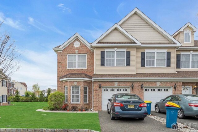 view of property with a garage and a front yard