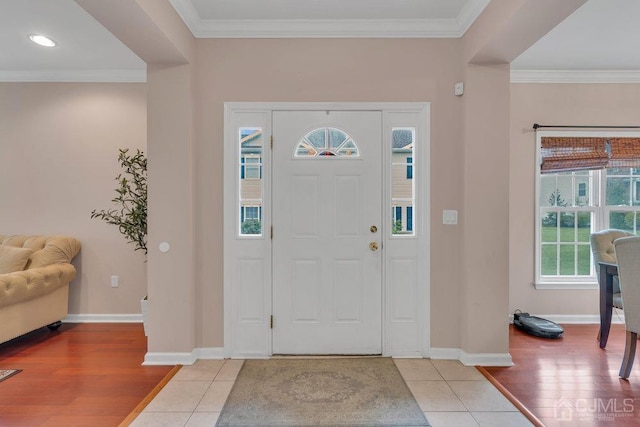 foyer with crown molding and hardwood / wood-style flooring