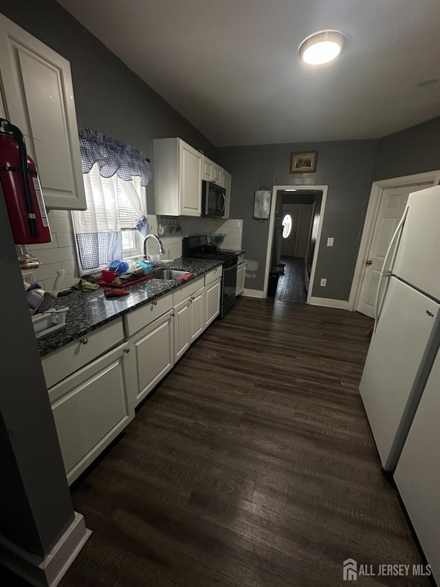 262 Hale St, New Brunswick, NJ 08901 - kitchen featuring dark wood finished floors, gas stove, dark stone counters, white cabinets, and a sink
