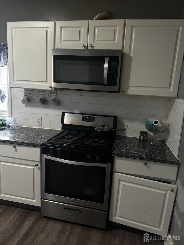 262 Hale St, New Brunswick, NJ 08901 - kitchen featuring white cabinets, stainless steel appliances, dark stone countertops, backsplash, and dark wood-type flooring
