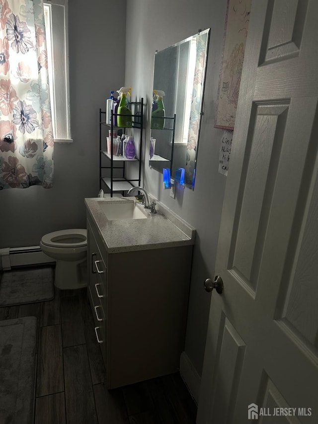 262 Hale St, New Brunswick, NJ 08901 - bathroom with vanity, toilet, wood finish floors, and a baseboard heating unit