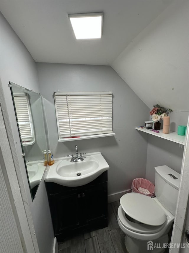 262 Hale St, New Brunswick, NJ 08901 - half bath with wood finished floors, toilet, vanity, baseboards, and lofted ceiling