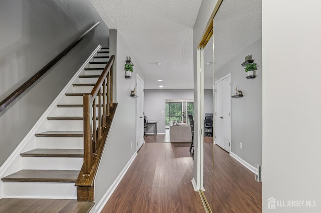91 Pear Tree Ln, Franklin, NJ 08823 - stairs with wood finished floors and a textured ceiling