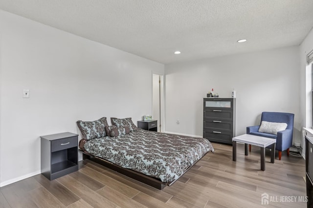 91 Pear Tree Ln, Franklin, NJ 08823 - bedroom featuring a textured ceiling, recessed lighting, and wood finished floors