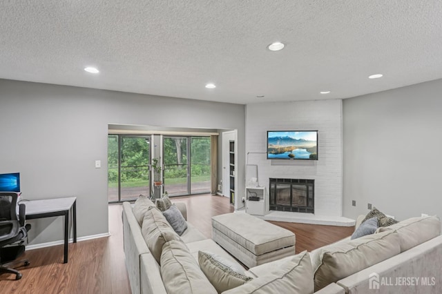 91 Pear Tree Ln, Franklin, NJ 08823 - living area with a textured ceiling, recessed lighting, wood finished floors, and a fireplace
