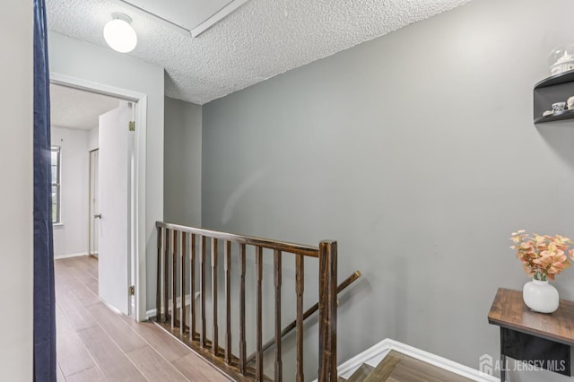 91 Pear Tree Ln, Franklin, NJ 08823 - hall with an upstairs landing, a textured ceiling, and wood finished floors