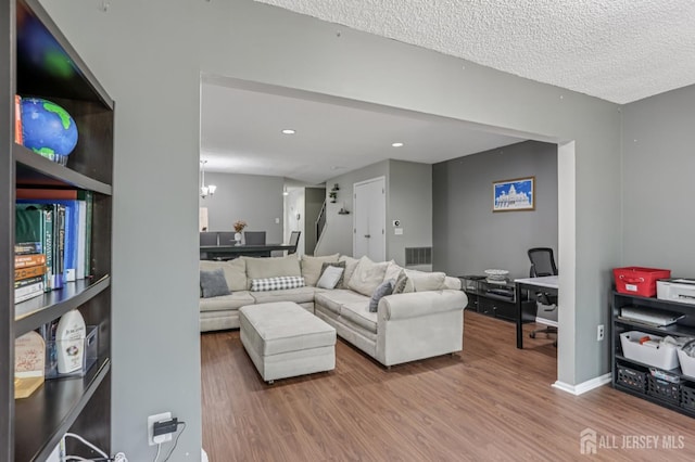 91 Pear Tree Ln, Franklin, NJ 08823 - living room with wood finished floors, a chandelier, recessed lighting, and a textured ceiling