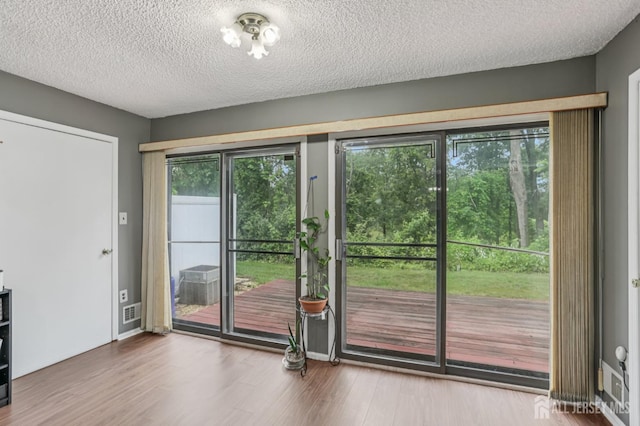 91 Pear Tree Ln, Franklin, NJ 08823 - doorway with wood finished floors and a textured ceiling