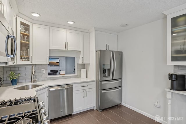 91 Pear Tree Ln, Franklin, NJ 08823 - kitchen featuring stainless steel appliances, light countertops, white cabinets, recessed lighting, and a textured ceiling