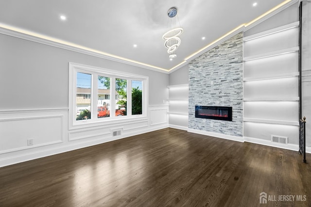 4 Arden Rd, Old Bridge, NJ 08857 - unfurnished living room featuring vaulted ceiling, crown molding, built in shelves, wainscoting, and a large fireplace