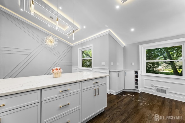 4 Arden Rd, Old Bridge, NJ 08857 - kitchen featuring a decorative wall, dark wood-type flooring, light stone counters, vaulted ceiling, and hanging light fixtures