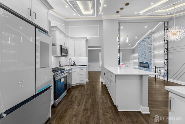 4 Arden Rd, Old Bridge, NJ 08857 - kitchen with stainless steel appliances, ornamental molding, dark wood-style floors, a sink, and white cabinets