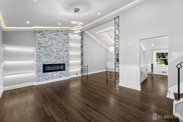4 Arden Rd, Old Bridge, NJ 08857 - unfurnished living room with wood finished floors, vaulted ceiling, a decorative wall, a fireplace, and ornamental molding