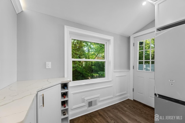 4 Arden Rd, Old Bridge, NJ 08857 - entryway with dark wood-style flooring, lofted ceiling, and a wainscoted wall