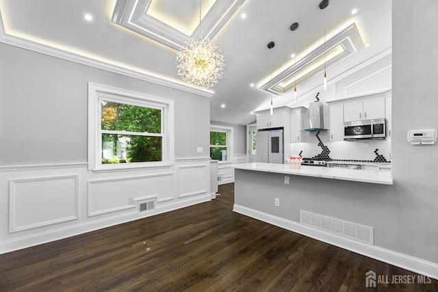4 Arden Rd, Old Bridge, NJ 08857 - kitchen featuring stainless steel microwave, wall chimney exhaust hood, a chandelier, a skylight, and light stone countertops