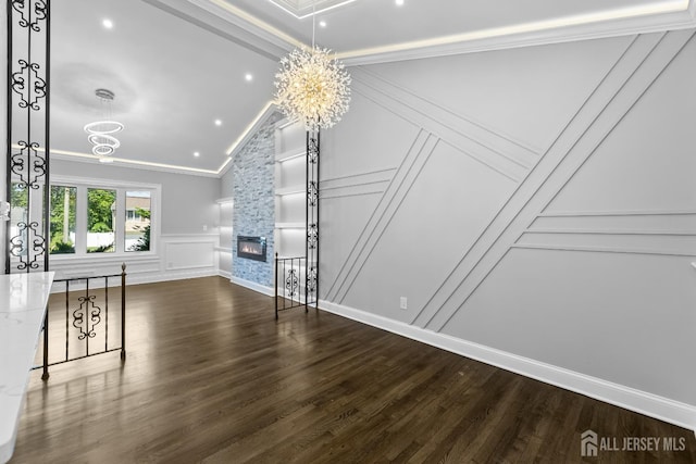 4 Arden Rd, Old Bridge, NJ 08857 - unfurnished living room featuring a decorative wall, a chandelier, crown molding, wood finished floors, and lofted ceiling