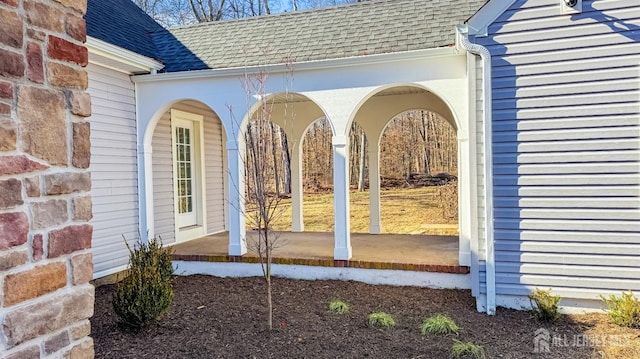 property entrance with roof with shingles