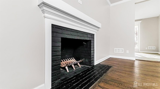 details featuring wood finished floors, a fireplace with flush hearth, visible vents, baseboards, and ornamental molding