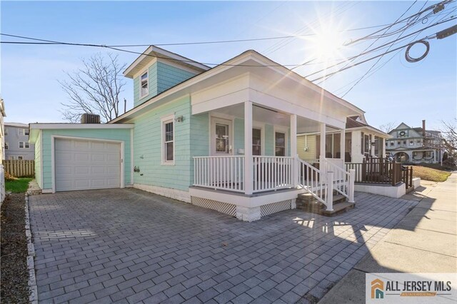 view of front of property with a porch and a garage