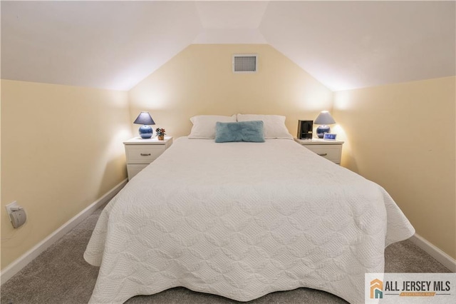 bedroom with vaulted ceiling and carpet flooring