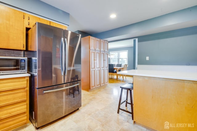 24 Christopher Ave, South Brunswick, NJ 08824 - kitchen with stainless steel appliances, a breakfast bar, light countertops, and recessed lighting