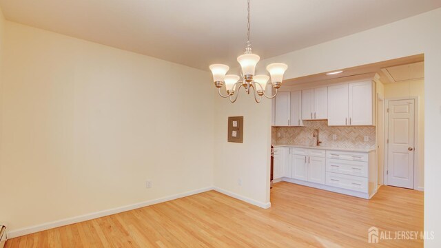 3 Cypress St Unit C, Toms River, NJ 08757 - unfurnished dining area featuring light wood-type flooring, a chandelier, and attic access