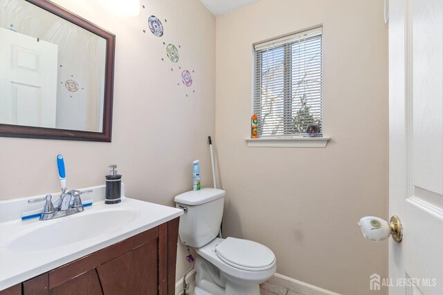 bathroom featuring toilet and vanity