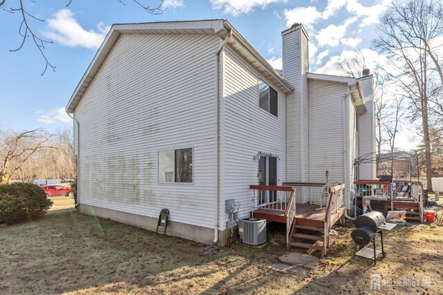 rear view of house featuring a deck and central air condition unit