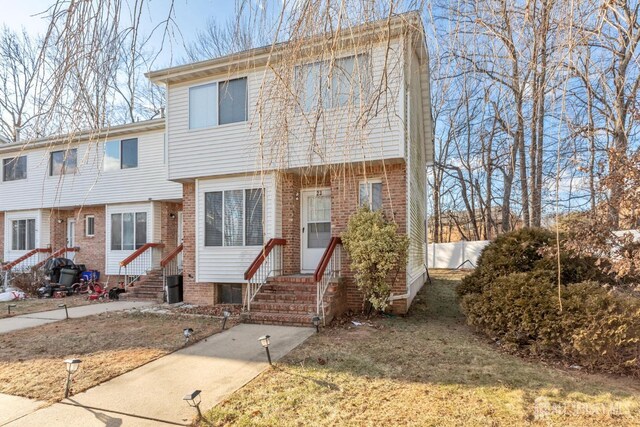 townhome / multi-family property featuring a front yard