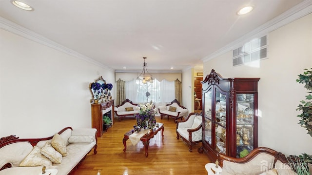 living area featuring ornamental molding and hardwood / wood-style floors